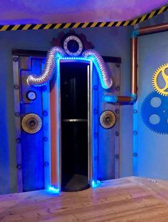 an open door in the middle of a room with blue lights and gears on it