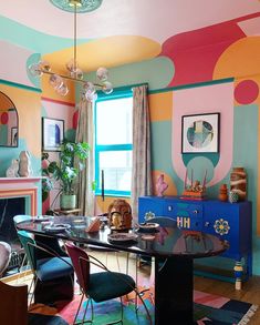 a dining room with colorful walls and furniture