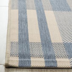 a blue and white checkered rug on the floor