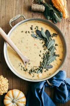 a pot filled with soup and topped with herbs