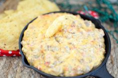 a skillet filled with cheese and tortilla chips next to some other food