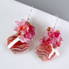 I love these focals! They are Argentine rhodochrosite gems and measure 22x20mm. They have been wrapped in sterling silver wire and dangle below a gorgeous combination of smooth ruby briolettes, pink moonstone, pink sapphire, white branch coral. Each bead is meticulously wrapped onto it's own head pin. The entire cluster is topped. I have used simple sterling ear wires. The earrings measure 1 3/4 (44mm.) from the top of the ear wires. Black Freshwater Pearls, Pink Moonstone, Gold Chandelier Earrings, Amethyst Gold, Green Opal, Aquamarine Stone, Gold Filled Earrings, Rhodolite Garnet, Lemon Quartz