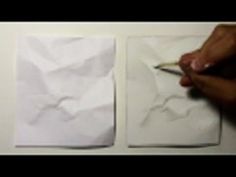 two pieces of white paper being folded on top of each other with a pencil in their hand