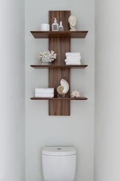 a wooden shelf with towels and other items on it, in the bathroom that is instagramted