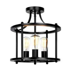 three light semi flush ceiling fixture in an antique black finish with clear glass and metal accents