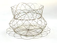 three wire baskets sitting on top of each other in front of a white background,