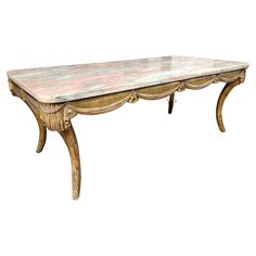 an old wooden table with marble top and gold trimmings on the legs, against a white background