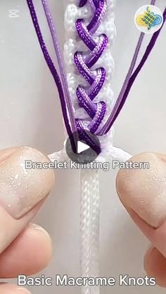 two hands holding purple and white braided bracelets with beading on the ends