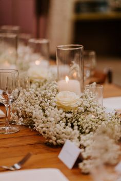 the table is set with flowers and candles