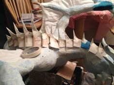 the paper mache is being made to look like a dragon