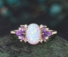 - Metal: Solid gold(10K/14K/18K white/yellow/rose gold),925 sterling silver,platinum available.- Main Stone: 6x8mm Oval cut lab opal- Accent Stone: Purple amethyst and moissanites or diamonds(G-H,Clarity SI-VS)- Band Width: 1.4mm- Can be personalized: Yes Opal And Amethyst Ring Engagement, Elegant White Amethyst Ring Gift, White Opal Ring With Gemstone Accents For Anniversary, White Opal Ring With Gemstone Accents As Gift, White Opal Ring With Gemstone Accents For Wedding, White Amethyst Wedding Ring, Elegant White Amethyst Wedding Ring, White Amethyst Gemstone Ring For Anniversary, Elegant White Opal Ring With Gemstone Accents