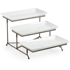 two serving trays with metal legs and white plates on each side, one is empty