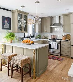 a kitchen island with two stools in front of it and an oven on the other side