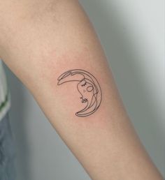 a woman's arm with a black and white tattoo design on the left forearm