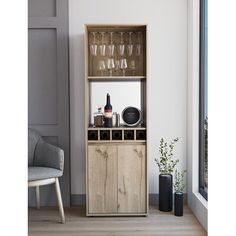 a wooden cabinet with wine glasses and bottles