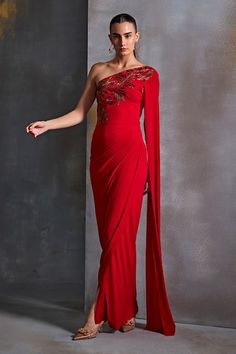 Buy Red Jersey Embroidery Plumeria Cut Dana One Shoulder Gown For Women by Namrata Joshipura Online at Aza Fashions. Elegant Red One-shoulder Wedding Dress, Elegant Red One Shoulder Wedding Dress, Red One Shoulder Gown For Wedding, One Shoulder Red Gown For Wedding, Red One Shoulder Wedding Gown, Red One Shoulder Dress For Wedding, Festive Evening Dress With Cape Sleeves For Gala, Festive Gala Evening Dress With Cape Sleeves, One-shoulder Gown With Draped Sleeves For Wedding