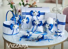 a table topped with lots of white and blue items