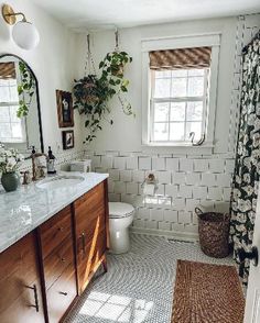 a bathroom with white tile and wooden cabinets