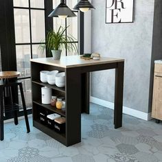 a kitchen with a table, stools and potted plant