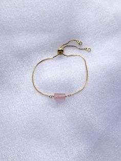 "This bracelet is a must have for your wardrobe! A rough cut gemstone bead is wire wrapped to a comfortable adjustable bracelet chain. It comes in your choice of sparkly gold, silver, or rose gold finish. It comes packaged with care in a beautiful gift box. *For more bracelets: https://www.etsy.com/shop/saraweberjewelry/?section_id=7769955 M A T E R I A L S * & * S I Z E * Natural Stone * Chain - Rose gold plated, gold plated, or rhodium plated * Length - Adjustable 5.5\" - 9\" P R O D U C T Gold Rose Quartz Bracelets For Jewelry Making, Elegant Rose Quartz Crystal Bracelet For Gift, Elegant Rose Quartz Crystal Bracelet Gift, Elegant Pink Resizable Beaded Bracelets, Delicate Adjustable Crystal Bracelet With Gemstone, Delicate Adjustable Crystal Gemstone Bracelet, Adjustable Gold Rose Quartz Jewelry, Elegant Gold Bracelets With Rose Quartz, Rose Gold Gemstone Bracelets For Wedding