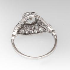 Circa 1930s ring is centered with one (1) old mine cut diamond set into a bezel. The gallery features a pierced design, bordered with milgrain edging and accented thirty-two (32), bead set, round single cut diamonds. The ring measures 11.5mm at the top, rises 5.4mm above the finger, tapering to 1.1mm wide and 0.8mm thick at the base of the shank. We offer complimentary ring sizing to fit. Art Deco Ring With Bezel Setting, Formal Diamond Ring With Rose Cut Round Stone, Formal Rose Cut Diamond Ring With Round Stone, Formal Rose Cut Diamond Ring, Platinum Art Deco Ring With Bezel Setting, Vintage Rose Cut Round Diamond Ring, Antique Diamond Ring With Bezel Setting, Art Deco Diamond White Ring With Bezel Setting, Art Deco White Diamond Ring With Bezel Setting