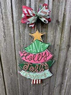 a wooden christmas tree hanging on a fence