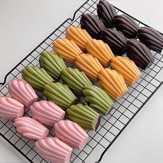 there are many different types of macaroons on the cooling rack