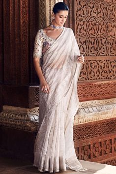 Experience the seamless blend of tradition and modernity with our exquisite royal nandi tissue sari in ivory. This exceptional piece is adorned with multicolor aari work, gota work, and meticulously-done hand embroidery, showcasing the rich heritage of indian craftsmanship. The intricate patterns lining the delicate tissue fabric, combined with an unconventional tasseled pallu, create an unforgettable sari that epitomizes the strength and grace of the Indian woman. Tissue Fabric, Gota Work, Indian Woman, Aari Work, Intricate Patterns, Photographic Lighting, Simple Life, Every Girl, Petticoat