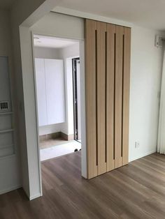 an empty room with wood flooring and sliding doors