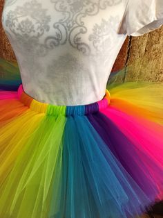 a white t - shirt and colorful tulle skirt