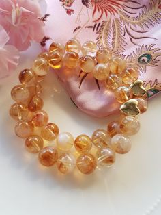 Love this gorgeous Citrine with its Cognac colours and its delightful citrine clouds, just so pretty! This Citrine gemstone bracelet will delight you its gorgeous colours, each individual citrine bead is so special and unique. I have used size 10mm Cloudy Citrine beads in this lovely bracelet and this charming Bracelet features a Gold plated Heart bead making a beautiful focal peace. The bracelets are approximately 19cm.  Citrine is a beautiful gemstone with beautiful energy, regarded as a spiri Amber Citrine Beaded Bracelet Gift, Amber Citrine Beaded Bracelet As A Gift, Amber Citrine Beaded Bracelets As A Gift, Amber Gemstone Beads Crystal Bracelet As Gift, Amber Crystal Bracelet With Gemstone Beads As Gift, Spiritual Citrine Bracelet As A Gift, Citrine Gemstone Beads Crystal Bracelet As Gift, Citrine Gemstone Beads Bracelet As Gift, Orange Crystal Bracelet As Gift