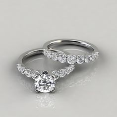 two wedding rings with diamond accents on each one and the other side, set in 18k white gold