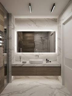 a bathroom with marble floors and white walls