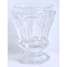 a clear glass vase sitting on top of a white table