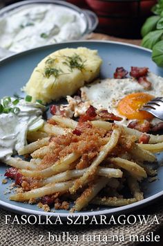 a blue plate topped with pasta and eggs