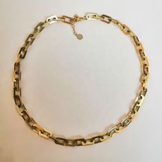 Introducing our stunning Chain Gang Necklace! This piece is the perfect addition to any jewelry collection. Made with 18k gold plated stainless steel, it's both beautiful and durable. The classic link chain design is timeless and versatile, making it perfect for any occasion. The Chain Gang Necklace has a length of 15" with a 2" extender, allowing you to adjust the length to your desired fit. You can wear it as a choker or let it hang as a longer necklace. The extender ensures that it fits perfe Gold Stainless Steel Jewelry With Rectangular Links, Tarnish Resistant Chain Necklace With Rectangular Links, Classic Stainless Steel Necklace With Chunky Chain, Tarnish Resistant Metal Link Chain Necklace, Stainless Steel Oval Link Chain Necklace As Gift, Oval Link Stainless Steel Chain Necklace As Gift, Stainless Steel Necklace With Rectangular Links For Gifts, Stainless Steel Gold Chain Necklace For Everyday, Everyday Stainless Steel Necklace With Gold Chain