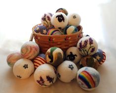 a basket filled with lots of different colored balls next to each other on top of a table