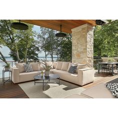 an outdoor living area with furniture and water view