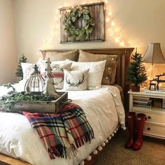 a bed with plaid blankets and christmas decorations