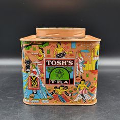 a tin can with an image of tosh's tea on it