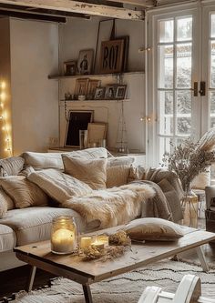 a living room filled with furniture next to a window covered in christmas lights and candles