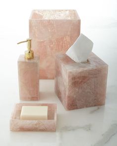 pink marble bathroom accessories including soap dispenser and tissue