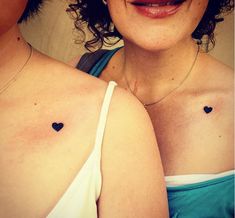 two women with small tattoos on their chests