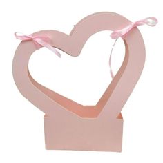 a pink heart shaped box with a bow on top