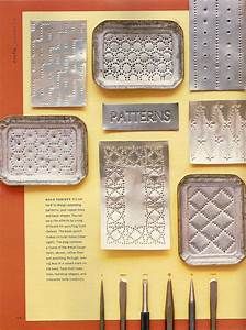 the book is open to show several metal trays with different designs and tools on them