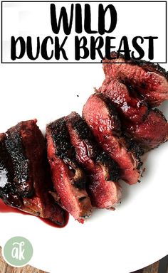 a white plate topped with meat covered in bbq sauce and text overlay reads wild duck breast