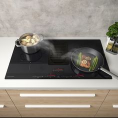 a pan with food cooking on top of a stove next to a pot and frying pan