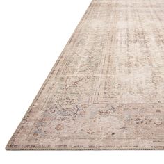 an antique looking rug with faded edges and medallions on the bottom, in neutral tones