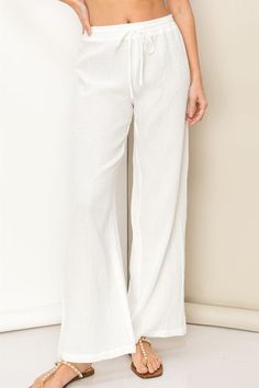 The perfect laid back style trouser for a relaxing day. With a cotton gauze construction, that gives a low rise silhouette. With an elastic waistband and drawstring, the comfort is unsurpassed. The wide cut legs add an elegant look. HF23F427 White Cotton Wide Leg Pants For Vacation, White Cotton Wide Leg Summer Pants, Summer White Cotton Wide Leg Pants, Relaxed Wide Leg Pants For Spring Lounging, Summer White Wide Leg Cotton Pants, Summer Lounging Pants With Elastic Waistband, Spring Wide Leg Lounging Pants With Drawstring, Chic Bottoms For Summer Lounging, Linen Bottoms With Elastic Waistband For Lounging