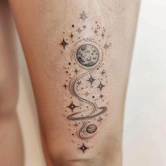 a woman's thigh with stars and planets on it